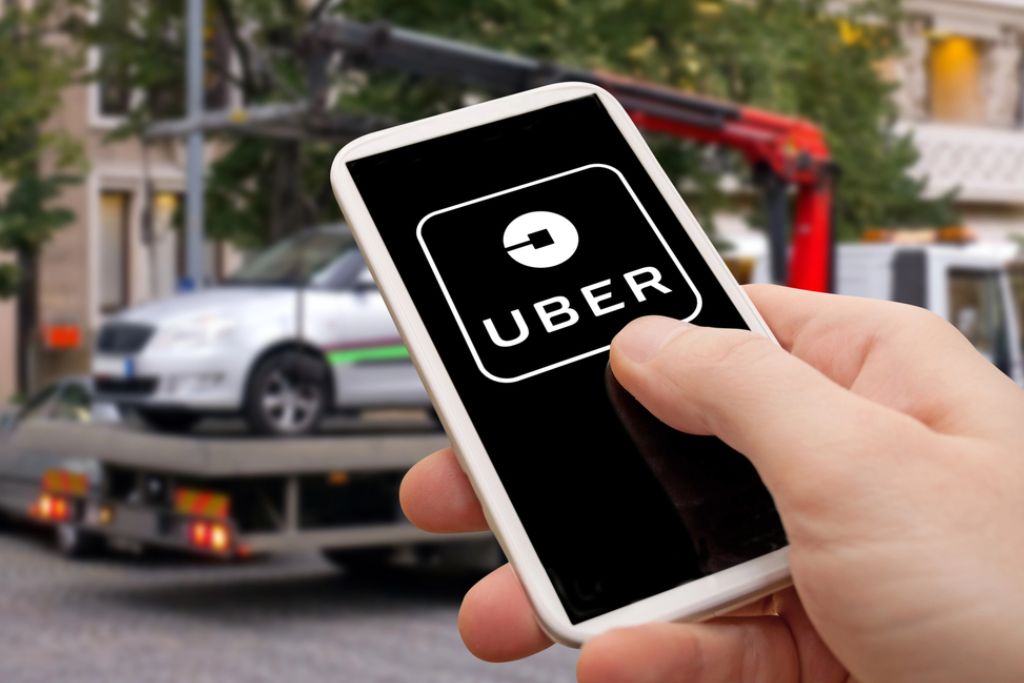 Person Holding Phone In A Backseat